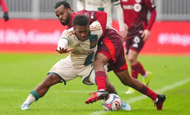 Toronto FC's Raheem Edwards, right, battles for the ball with Atlanta United's Matthew Edwards during the second half of an MLS soccer game in Toronto, Saturday, April 25, 2026. (Frank Gunn/The Canadian Press via AP)