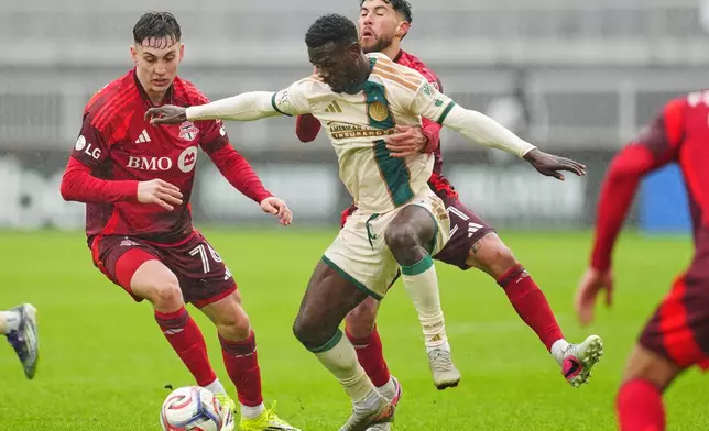 Toronto FC's Lazar Stefanović, left, and Jonathan Osorio, rear, battle for the ball with Atlanta United's Emmanuel Latte Lath (9) during the first half of an MLS soccer game in Toronto, Saturday, April 25, 2026. (Frank Gunn/The Canadian Press via AP)