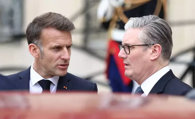 British Prime Minister Keir Starmer, right, and French President Emmanuel Macron speak as they leave after the multinational virtual summit and press conference at the Elysee Presidential Palace in Paris, Friday April 17, 2026 (Tom Nicholson/Pool Photo via AP)