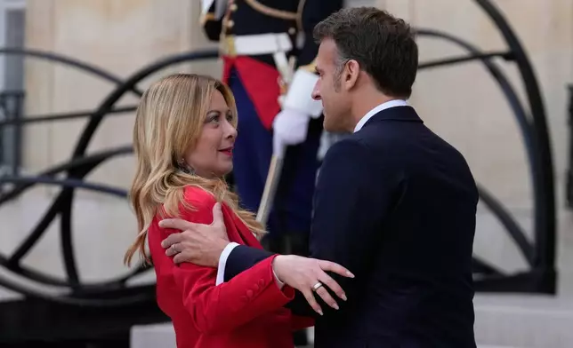 France's President Emmanuel Macron, right, welcomes Italian Premier Giorgia Meloni prior to an international summit to push forward efforts to reopen the Strait of Hormuz, at the Elysee Palace, in Paris, France, Friday, April 17, 2026. (AP Photo/Michel Euler)