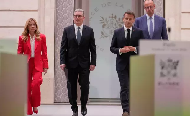 From left, Italian Premier Giorgia Meloni, Britain's Prime Minister Keir Starmer, France's President Emmanuel Macron and German Chancellor Friedrich Merz arrive to give a statement after an international summit to push forward efforts to reopen the Strait of Hormuz, at the Elysee Palace, in Paris, France, Friday, April 17, 2026. (AP Photo/Michel Euler, Pool)