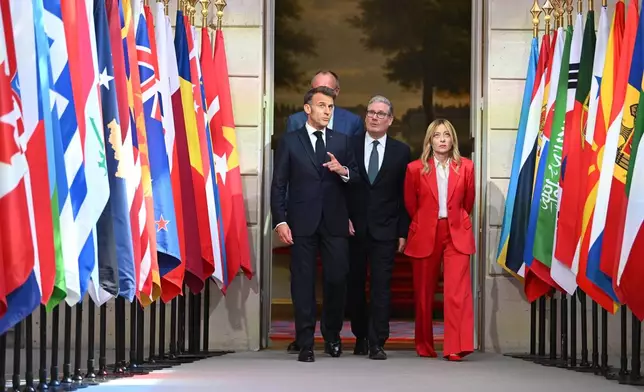 German chancellor Friedrich Merz, behind, French President Emmanuel Macron, left, British Prime Minister Keir Starmer, centre, and Italian Prime Minister Giorgia Meloni arrive at the Elysee Palace for a conference on the initiative for maritime navigation in the Strait of Hormuz, in Paris, Friday April 17, 2026 (Jeanne Accorsini/Pool Photo via AP)