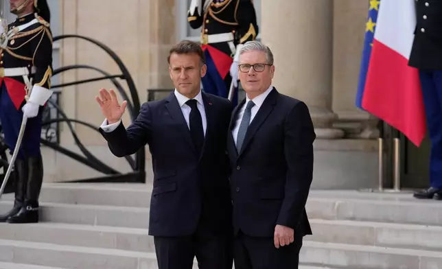 France's President Emmanuel Macron, left, welcomes British Prime Minister Keir Starmer prior to an international summit to push forward efforts to reopen the Strait of Hormuz, at the Elysee Palace, in Paris, France, Friday, April 17, 2026. (AP Photo/Michel Euler)