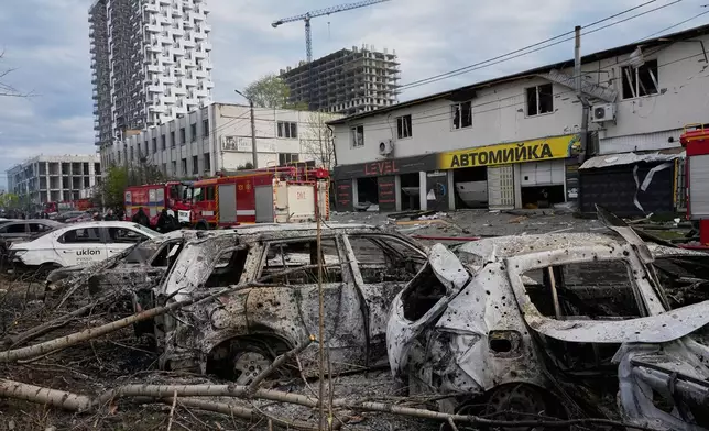 Burnt private cars on a damaged parking site following Russia's missile attack in Kyiv, Ukraine, Thursday, April 16, 2026. (AP Photo/Efrem Lukatsky)