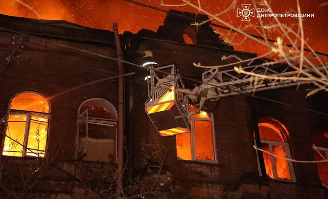In this photo provided by the Ukrainian Emergency Service, firefighters put out a fire following a Russian attack in Dnipro, Ukraine, Thursday, April 16, 2026. (Ukrainian Emergency Service via AP)