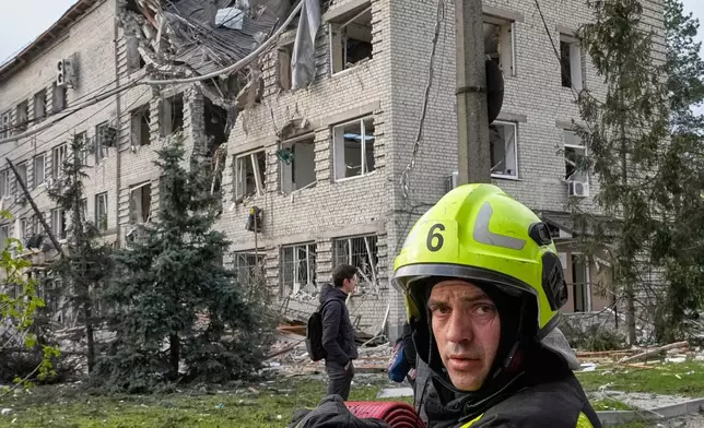A firefighter works at a damaged building following Russia's missile attack in Kyiv, Ukraine, Thursday, April 16, 2026. (AP Photo/Efrem Lukatsky)