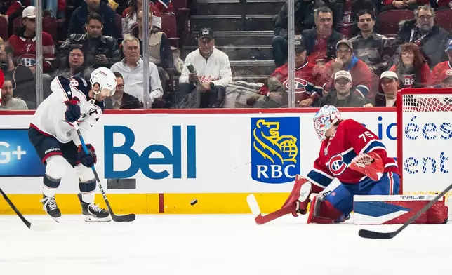 Columbus Blue Jackets' Boone Jenner (38) scores on Montreal Canadiens goaltender Jakub Dobes (75) during first period NHL hockey action, in Montreal on Saturday, April 11, 2026. (Christopher Katsarov/The Canadian Press via AP)