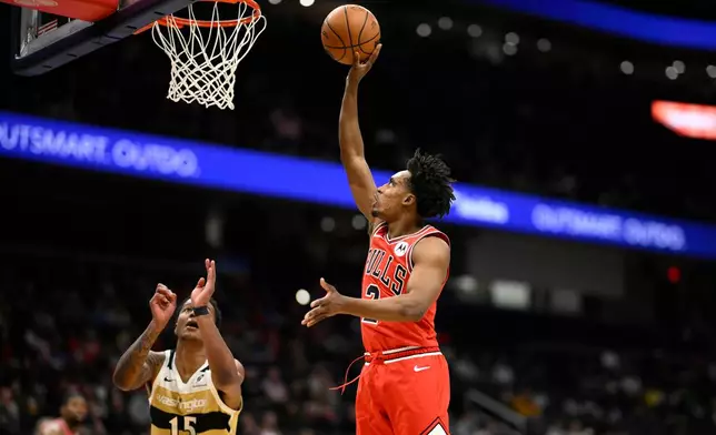 Chicago Bulls guard Collin Sexton, right, shoots against Washington Wizards forward Juju Reese (15) during the first half of an NBA basketball game, Thursday, April 9, 2026, in Washington. (AP Photo/Nick Wass)