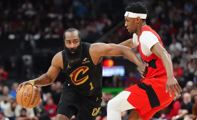 Cleveland Cavaliers guard James Harden (1) tries to move around Toronto Raptors guard Ja'kobe Walter, right, during the first half of Game 4 in a first-round NBA basketball playoffs series in Toronto, Sunday, April 26, 2026. (Frank Gunn/The Canadian Press via AP)