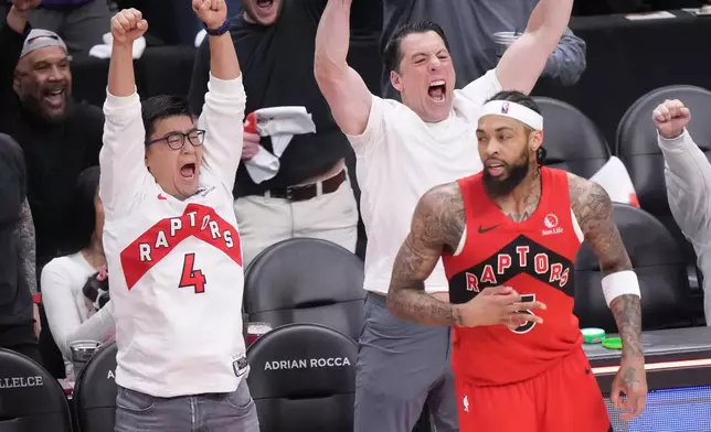 Fans react after Toronto Raptors forward Brandon Ingram, front, made a 3-point basket in the final minutes of the first half of Game 4 in a first-round NBA basketball playoffs series against the Cleveland Cavaliers in Toronto, Sunday, April 26, 2026. (Nathan Denette/The Canadian Press via AP)