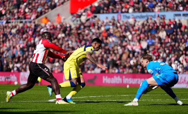 Sunderland's Brian Brobbey, left, push Tottenham Hotspur's Cristian Romero into Tottenham Hotspur goalkeeper Antonin Kinsky during the Premier League soccer match between Sunderland and Tottenham Hotspur, in Sunderland, England, Sunday April 12, 2026. (Owen Humphreys/PA via AP)