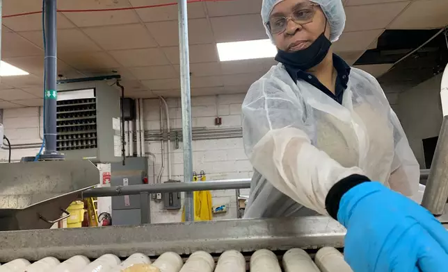 Better Made Snack Foods worker Tonya Tinsleydoes quality control checks on potatoes at a processing facility in Detroit, on Thursday, April 2, 2026 (AP Photo/Mike Householder)