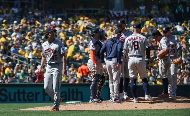Houston Astros pitcher Tatsuya Imai, left, leaves the mound as he is relieved by pitcher Kai-Wei Teng (not shown) during the sixth inning of a baseball game against the Athletics, Saturday, April 4, 2026, in West Sacramento, Calif. (AP Photo/Sara Nevis)