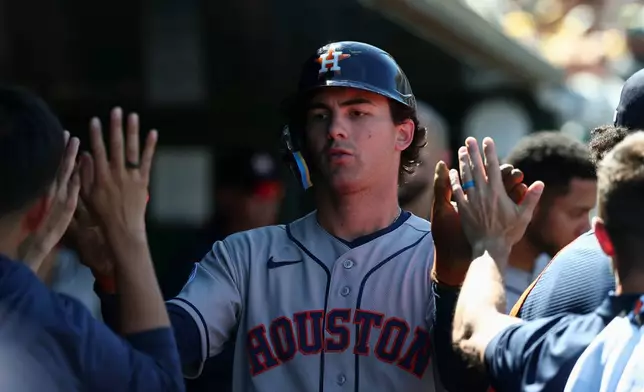 Houston Astros' Joey Loperfido celebrates in the dugout after scoring during the sixth inning of a baseball game against the Athletics, Saturday, April 4, 2026, in West Sacramento, Calif. (AP Photo/Sara Nevis)