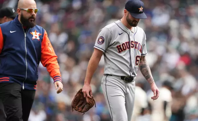 Houston Astros starting pitcher Cody Bolton leaves the game against the Seattle Marinersdue to injury with a trainer during the second inning of a baseball game, Sunday, April 12, 2026, in Seattle. (AP Photo/Lindsey Wasson)