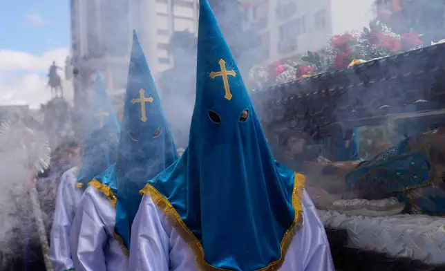 Hooded penitents participate in a Good Friday procession during Holy Week in La Paz, Bolivia, Friday, April 3, 2026. (AP Photo/Juan Karita)