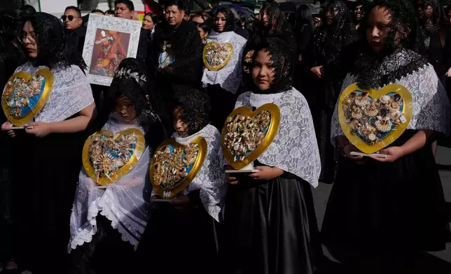 Young women and girls carry jeweled hearts representing the Virgin Mary at a Good Friday procession during Holy Week in La Paz, Bolivia, Friday, April 3, 2026. (AP Photo/Juan Karita)
