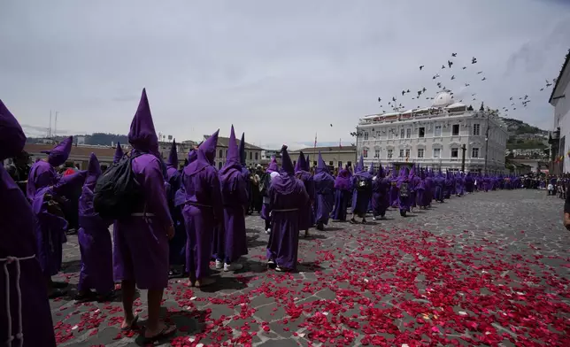 Hooded penitents known as "Cucuruchos" take part in the Jesus del Gran Poder procession in Quito, Ecuador, Friday, April 3, 2026. (AP Photo/Dolores Ochoa).