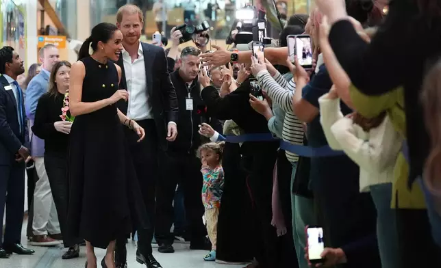 Britain's Prince Harry and Meghan Markle, the Duke and Duchess of Sussex, visit the Royal Children's Hospital Melbourne, Australia Tuesday, April 14, 2026. (Jonathan Brady/Pool Photo via AP)