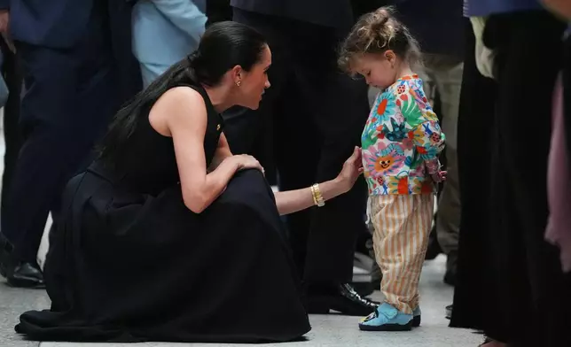 Meghan Markle, the Duchess of Sussex, meets a young child during a visit to the Royal Children's Hospital Melbourne, Australia Tuesday, April 14, 2026. (Jonathan Brady/Pool Photo via AP)