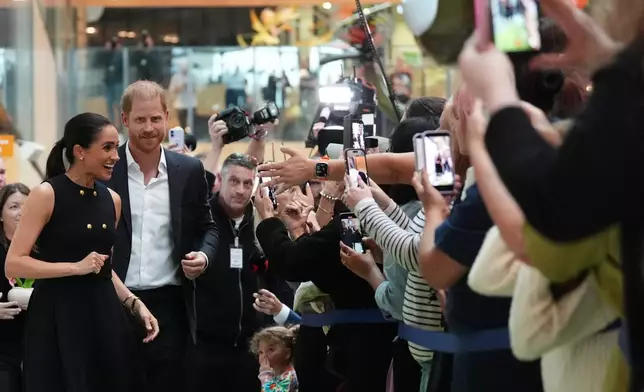 Britain's Prince Harry and Meghan Markle, the Duke and Duchess of Sussex, visit the Royal Children's Hospital Melbourne, Australia Tuesday, April 14, 2026. (Jonathan Brady/Pool Photo via AP)