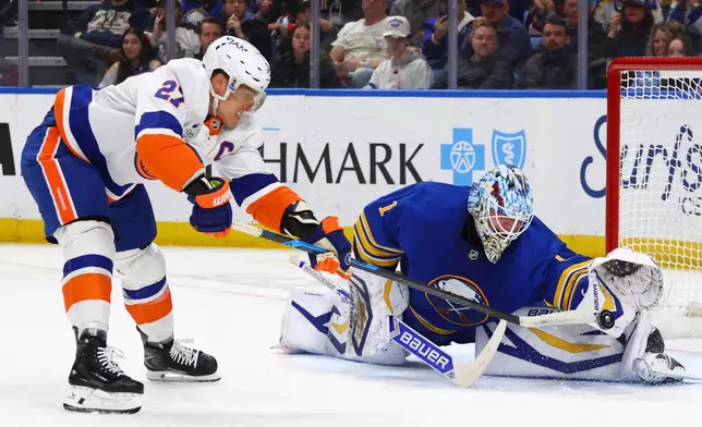 Buffalo Sabres goaltender Ukko-Pekka Luukkonen (1) stops New York Islanders left wing Anders Lee (27) on a penalty shot during the second period of an NHL hockey game Tuesday, March 31, 2026, in Buffalo, N.Y. (AP Photo/Jeffrey T. Barnes)