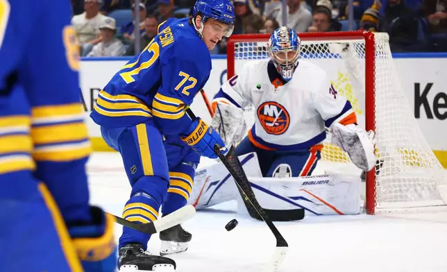 Buffalo Sabres center Tage Thompson (72) tips the puck in front of New York Islanders goaltender Ilya Sorokin (30) during the first period of an NHL hockey game Tuesday, March 31, 2026, in Buffalo, N.Y. (AP Photo/Jeffrey T. Barnes)