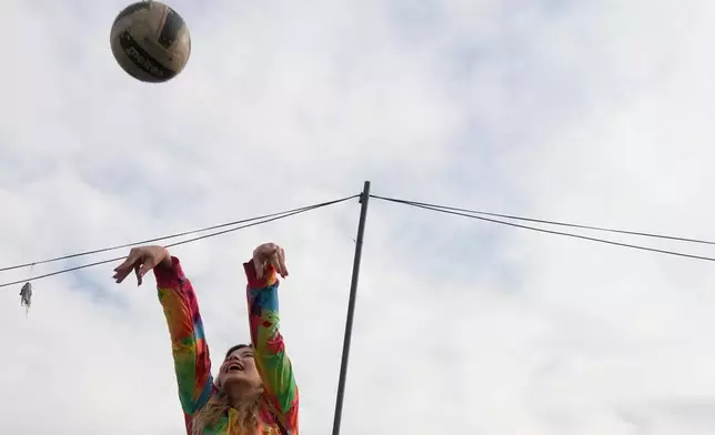 A woman plays volleyball at Pardisan Park in Tehran, Iran, Friday, April 10, 2026. (AP Photo/Vahid Salemi)