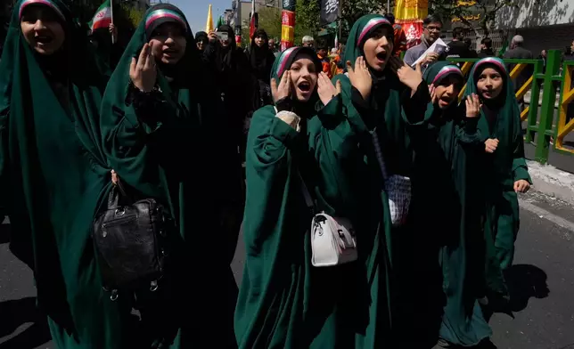 Girls sing during a mourning ceremony marking the 40th day since the death of Iranian Supreme Leader Ayatollah Ali Khamenei, who was killed in the U.S. and Israel strikes in Tehran, Iran, Thursday, April 9, 2026. (AP Photo/Vahid Salemi)