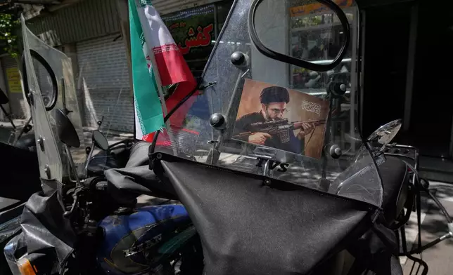 A poster is pasted on a motorbike windshield with graphic depicting Iran's Supreme Leader Ayatollah Mojtaba Khamenei as government supporters gather to mark the 40th day since the killing of his father, Supreme Leader Ayatollah Ali Khamenei, in Tehran, Iran, Thursday, April 9, 2026. (AP Photo/Vahid Salemi)