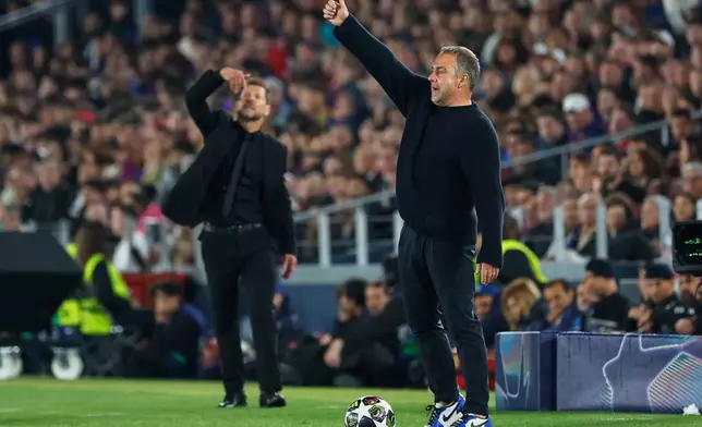 Barcelona's head coach Hansi Flick, right, and Atletico Madrid's head coach Diego Simeone react during the Champions League quarterfinal first leg soccer match between Barcelona and Atletico Madrid in Barcelona, Spain, Wednesday, April 8, 2026. (AP Photo/Joan Monfort)
