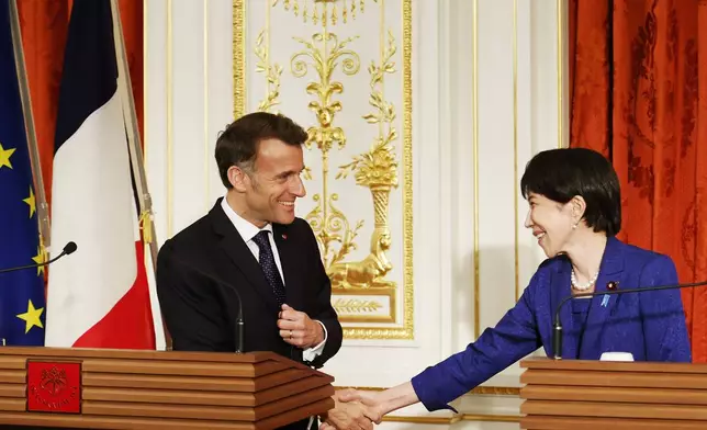 French President Emmanuel Macron, left, and Japanese Prime Minister Sanae Takaichi shake hands during a joint press conference at the Akasaka Palace state guest house in Tokyo Wednesday, April 1, 2026. (Franck Robichon/Pool Photo via AP)