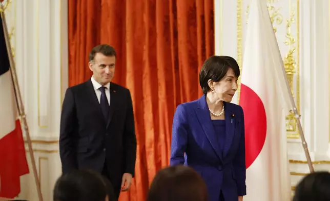 Japanese Prime Minister Sanae Takaichi, right, and French President Emmanuel Macron arrive for signing ceremony at the Akasaka Palace state guest house in Tokyo Wednesday, April 1, 2026. (Franck Robichon/Pool Photo via AP)