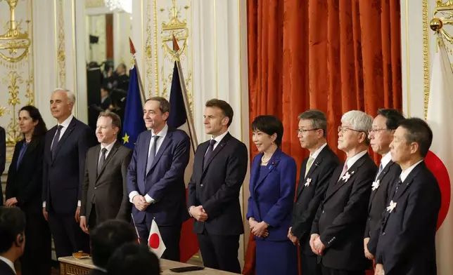 Japanese Prime Minister Sanae Takaichi, center right, and French President Emmanuel Macron, center left, pose for a group photo during signing ceremony at the Akasaka Palace state guest house in Tokyo Wednesday, April 1, 2026. (Franck Robichon/Pool Photo via AP)