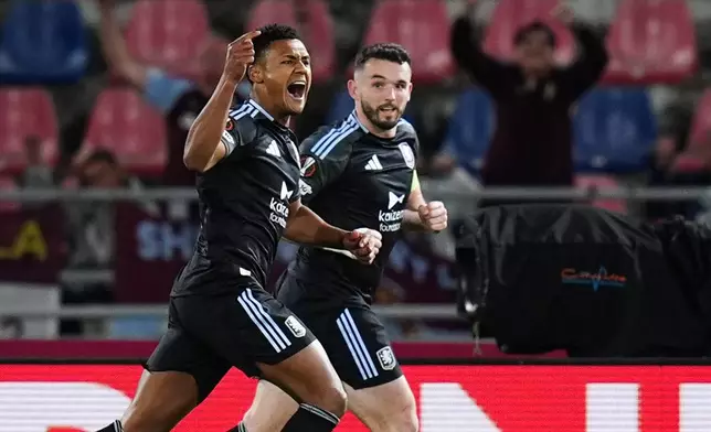 Aston Villa's Ollie Watkins, left, celebrates scoring during the Europa League soccer match between Bologna and Aston Villa in Bologna, Italy, Thursday April 9, 2026. (Massimo Paolone/LaPresse via AP)