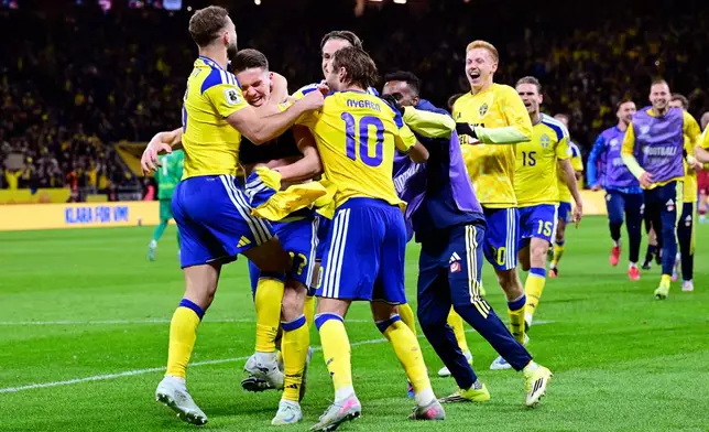 Sweden's Viktor Gyökeres, second from left, celebrates with teammates after scoring during a World Cup qualifying playoff final soccer match between Sweden and Poland in Stockholm, Tuesday, March 31, 2026. (Jonas Ekstromer/TT via AP)