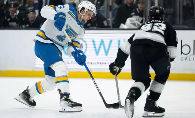 St. Louis Blues defenseman Philip Broberg (6) shoots as Los Angeles Kings defenseman Brandt Clarke (92) defends during the first period of an NHL hockey game, Wednesday, April 1, 2026, in Los Angeles. (AP Photo/Kyusung Gong)