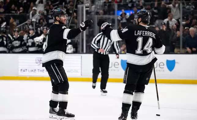 Los Angeles Kings right wing Adrian Kempe, left, and right wing Alex Laferriere celebrate a goal by Kempe during the second period of an NHL hockey game against the St. Louis Blues, Wednesday, April 1, 2026, in Los Angeles. (AP Photo/Kyusung Gong)