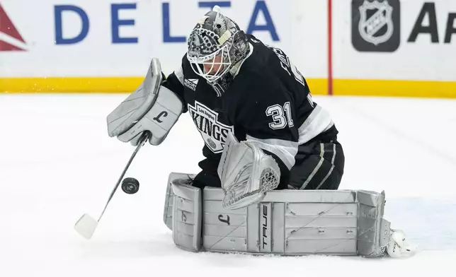 Los Angeles Kings goaltender Anton Forsberg (31) blocks a shot during the first period of an NHL hockey game against the St. Louis Blues, Wednesday, April 1, 2026, in Los Angeles. (AP Photo/Kyusung Gong)