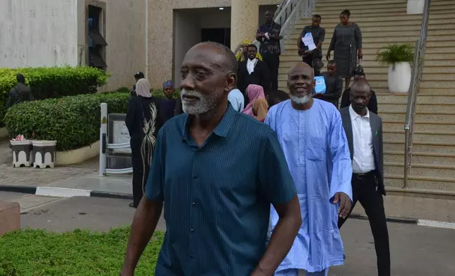 People accused of plotting to overthrow Nigerian President Bola Tinubu arrive at the federal high court in Abuja, Nigeria, Wednesday, April 22, 2026. (AP Photo/Gbemiga Olamikan)