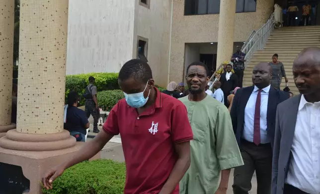 People accused of plotting to overthrow Nigerian President Bola Tinubu arrive at the federal high court in Abuja, Nigeria, Wednesday, April 22, 2026. (AP Photo/Gbemiga Olamikan)