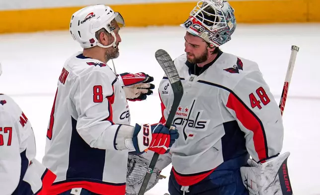 Washington Capitals' Alex Ovechkin (8) celebrates with goaltender Logan Thompson (48) after an NHL hockey game against the Pittsburgh Penguins in Pittsburgh, Saturday, April 11, 2026. (AP Photo/Gene J. Puskar)