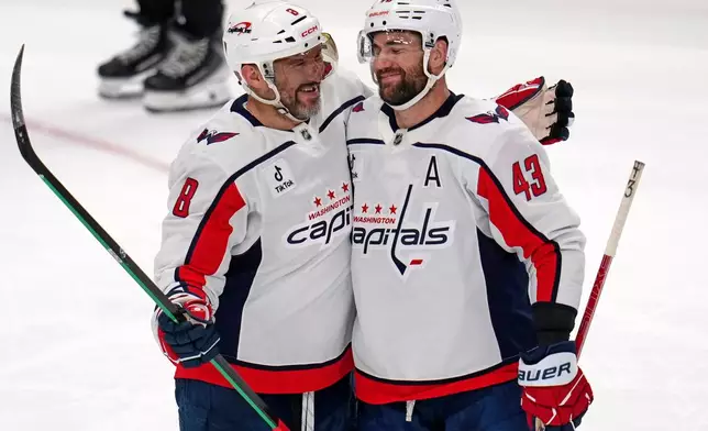 Washington Capitals' Alex Ovechkin (8) celebrates with Tom Wilson after scoring an empty-net goal during the third period of an NHL hockey game against the Pittsburgh Penguins in Pittsburgh, Saturday, April 11, 2026. (AP Photo/Gene J. Puskar)