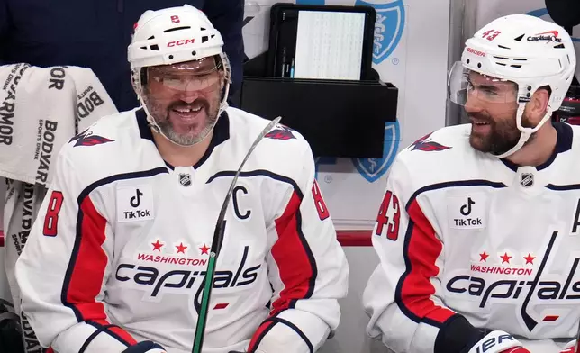 Washington Capitals' Alex Ovechkin (8) sits on the bench with Tom Wilson (43) after scoring on a empty-net during the third period of an NHL hockey game against the Pittsburgh Penguins in Pittsburgh, Saturday, April 11, 2026. (AP Photo/Gene J. Puskar)