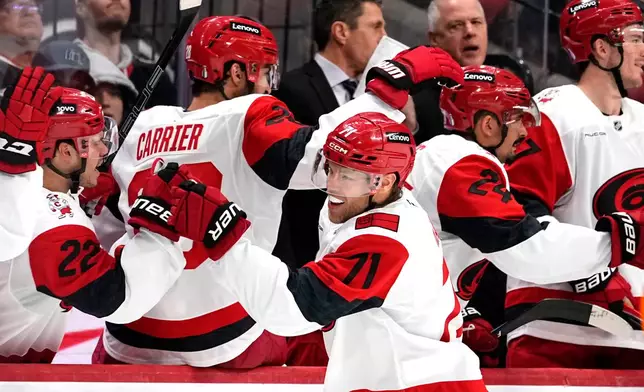 Carolina Hurricanes' Taylor Hall (71) celebrates at the benc after scoring a goal against the Ottawa Senators during the second period in Game 4 of a first-round NHL Stanley Cup playoff hockey series, Saturday, April 25, 2026, in Ottawa, Ontario. (Justin Tang/The Canadian Press via AP)