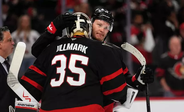 Ottawa Senators' Brady Tkachuk (7) embraces goaltender Linus Ullmark (35) after their team was eliminated by the Carolina Hurricanes after losing in Game 4 of a first-round NHL Stanley Cup playoff hockey series, Saturday, April 25, 2026, in Ottawa, Ontario. (Justin Tang/The Canadian Press via AP)