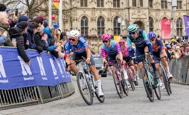 A group of riders compete during the Tour of Flanders in Oudenaarde, Belgium on Sunday, April 5, 2026. (AP Photo/Geert Vanden Wijngaert)