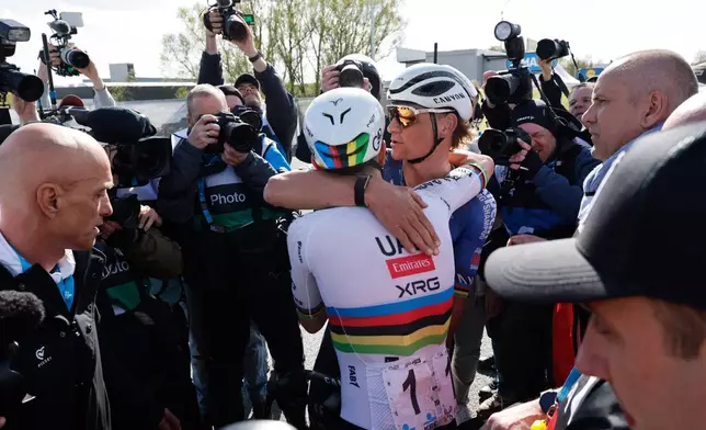Slovenia's Tadej Pogacar is congratulated by Netherland's Mathieu Van Der Poel afternoon winning the Tour of Flanders cycling race, in Oudenaarde, Belgium Sunday, April 5, 2026. (AP Photo/Geert Vanden Wijngaert)