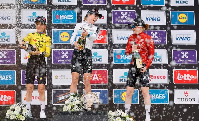 Netherland's Demi Vollering , center, celebrates after winning the Tour of Flanders cycling race, in front off France's Pauline Ferrand-Prevot, left, and Netherland's Puck Pieterse in Oudenaarde, Belgium Sunday, April 5, 2026. (AP Photo/Geert Vanden Wijngaert)