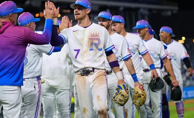 Kansas City Royals' Bobby Witt Jr. (7) celebrates with teammates after their baseball game against the Los Angeles Angels, Saturday, April 25, 2026, in Kansas City, Mo. (AP Photo/Charlie Riedel)